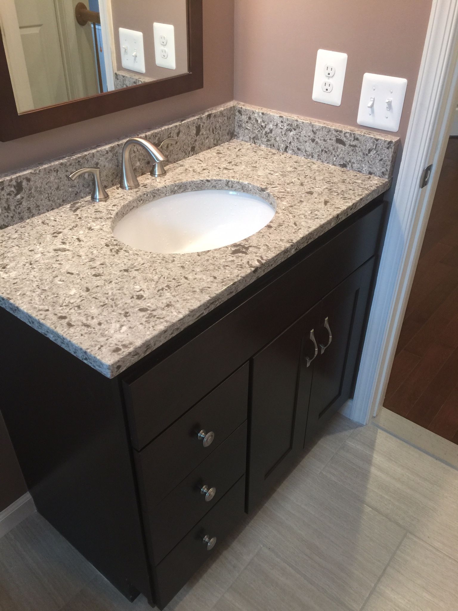 A bathroom vanity with a sink and a mirror
