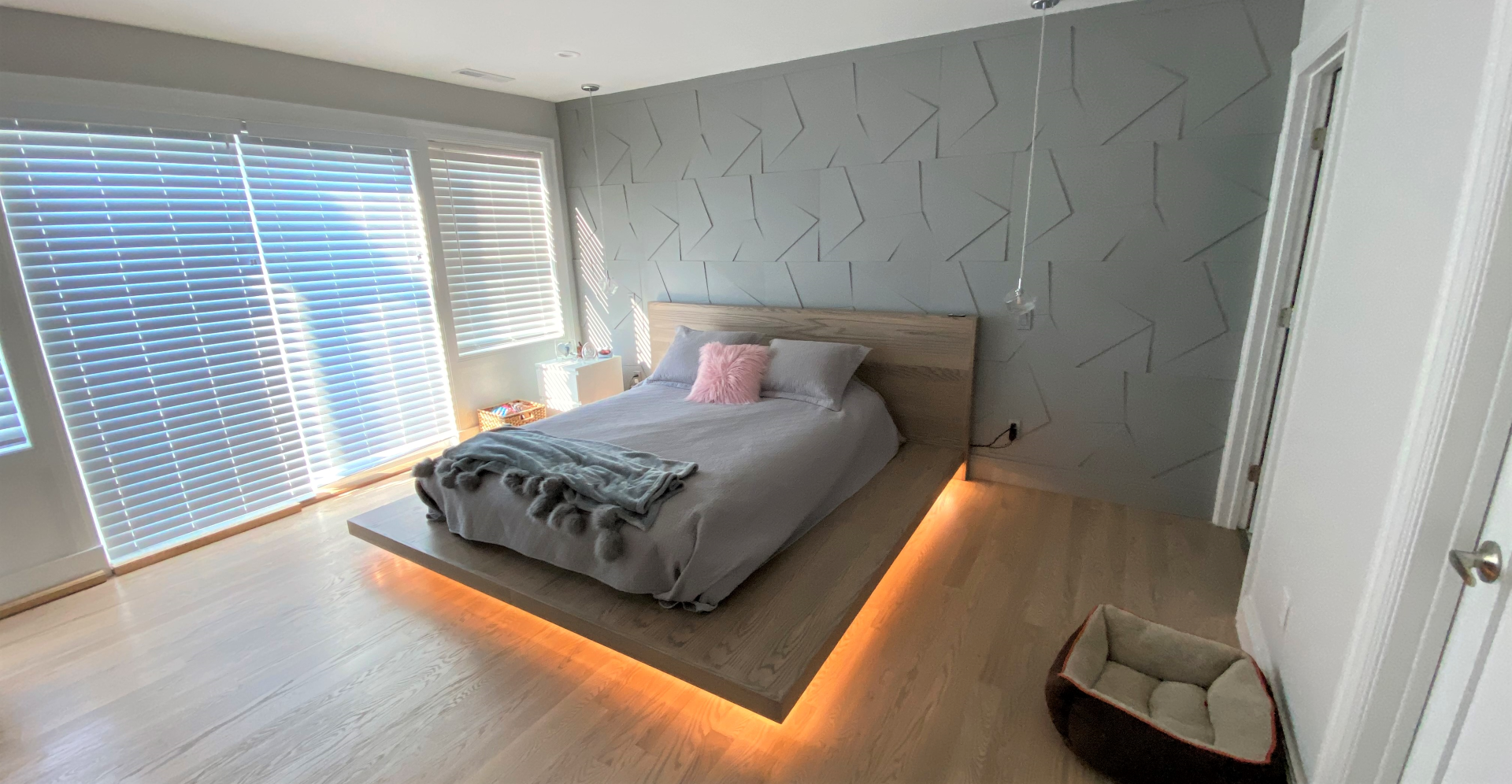 Custom cut geometric accent wall with light up platform bed