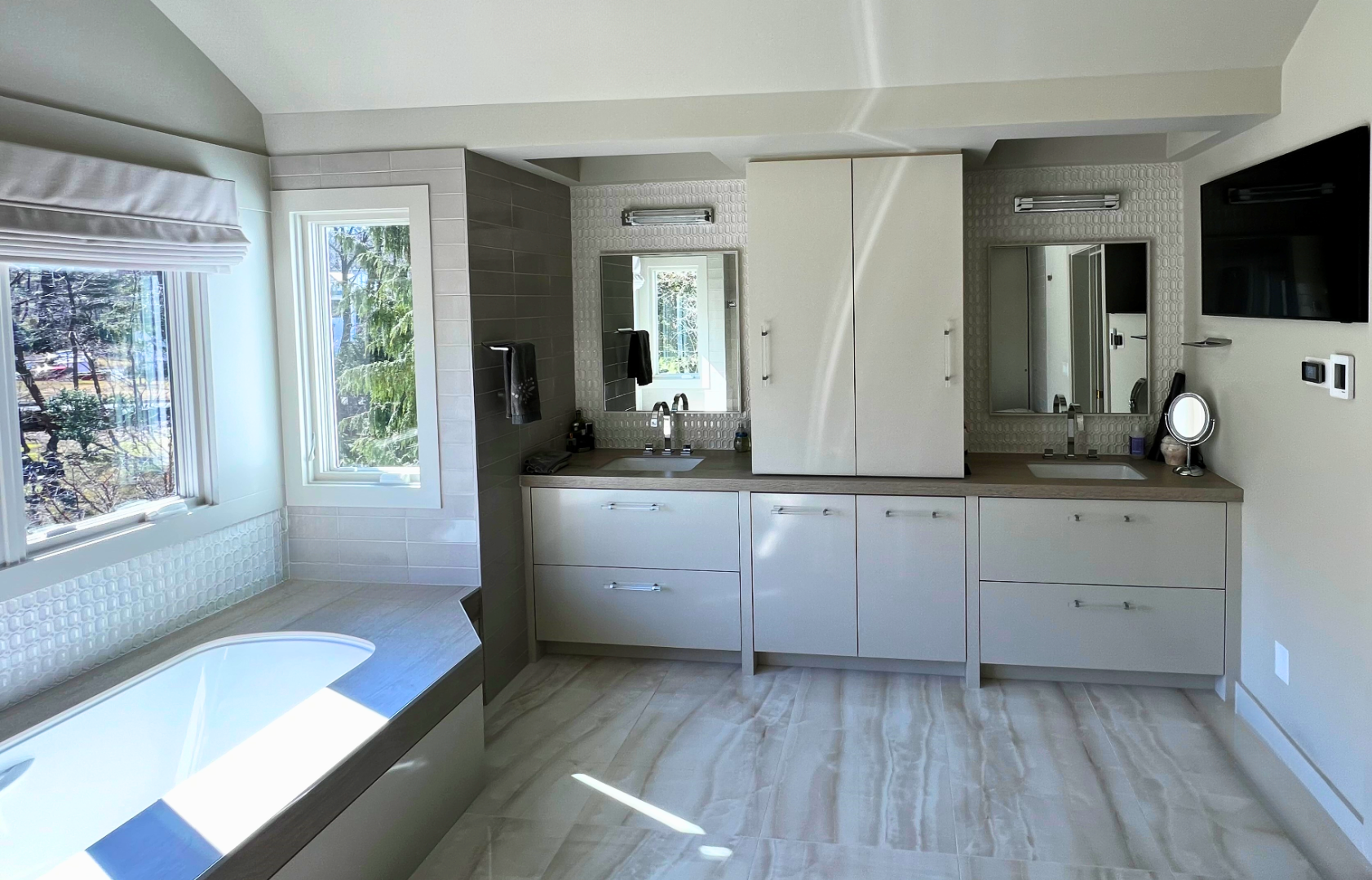 large spa-like bath with double vanity and tub surround