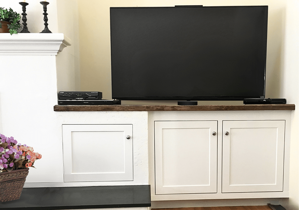 built-in cabinets in unused space next to fireplace