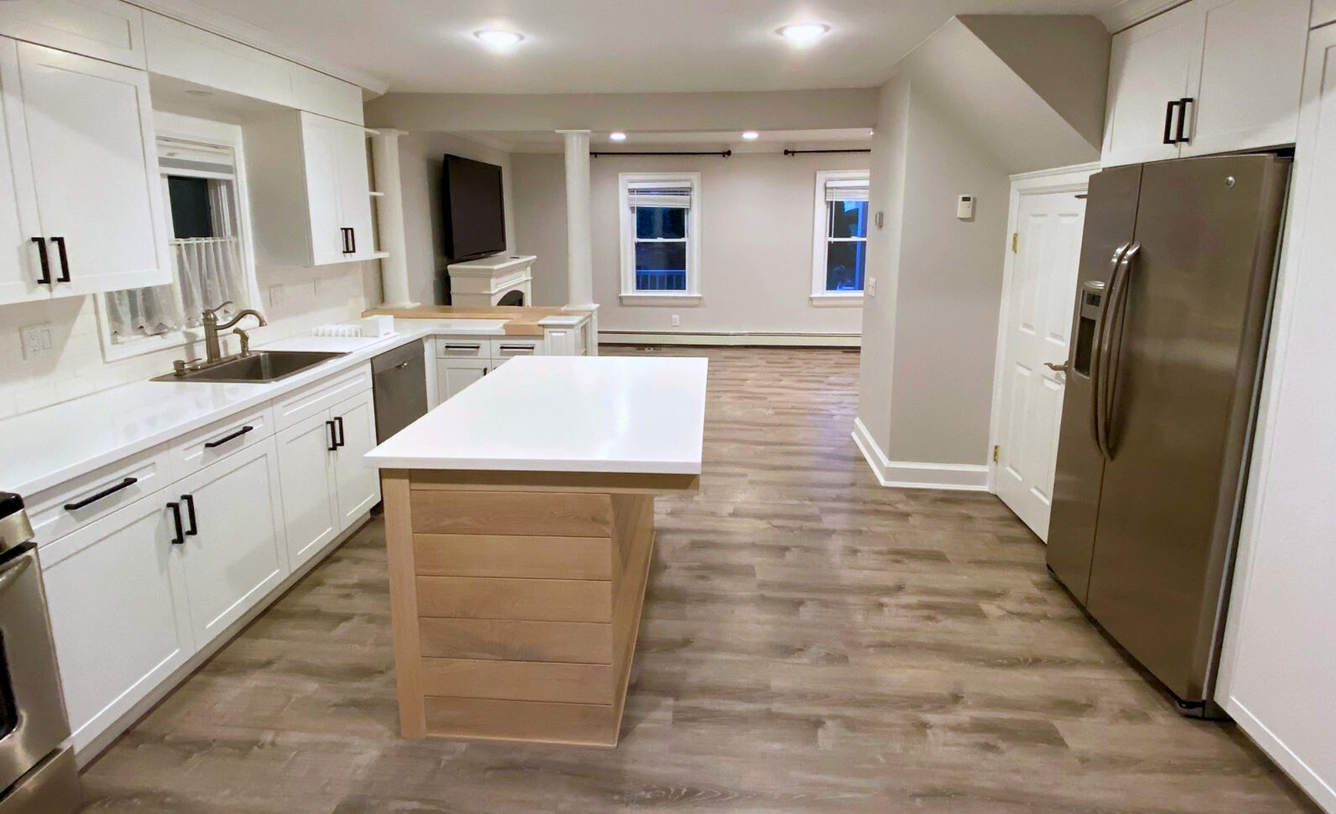 kitchen cabinets created for awkward layout with beams in ceiling