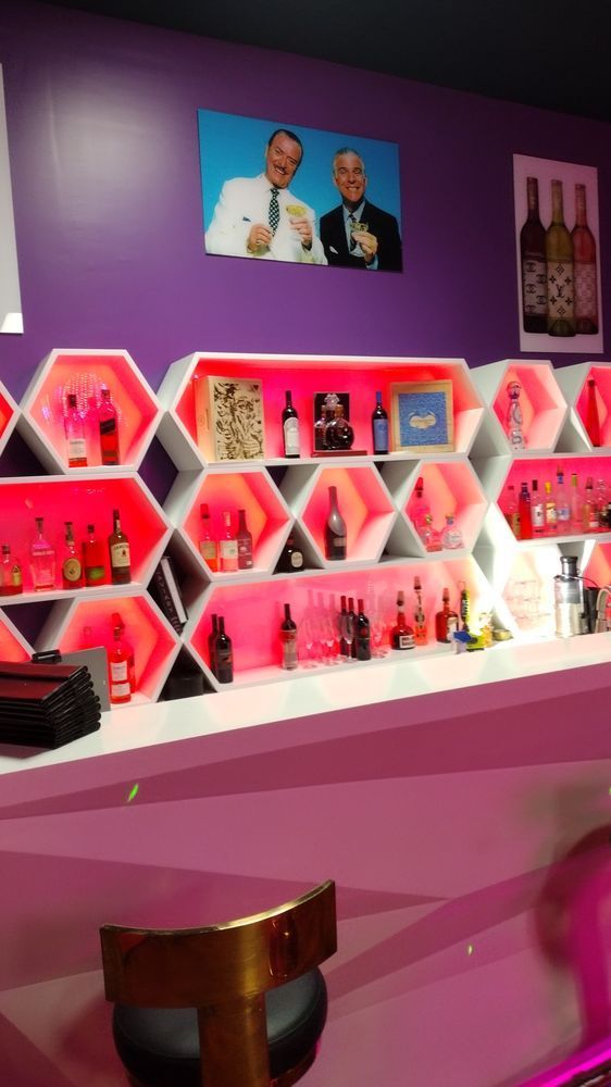 A bar with a picture of two men on the wall above it