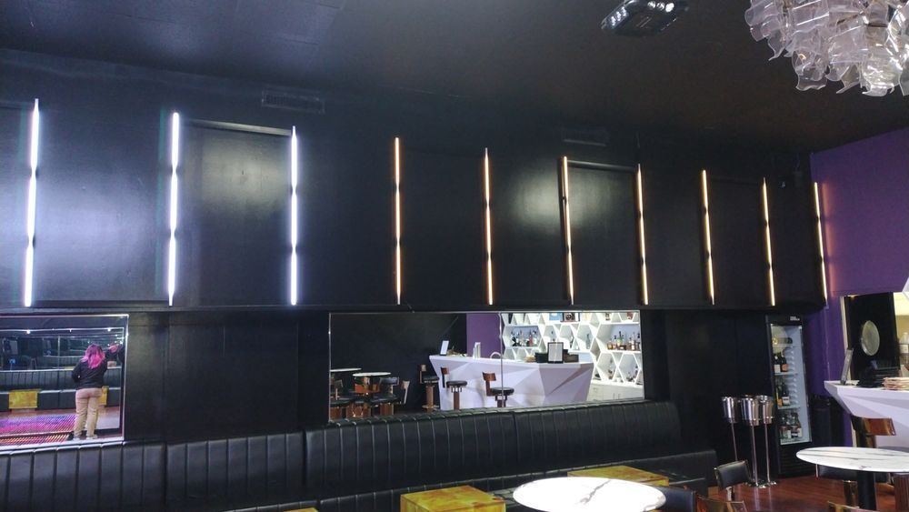 A restaurant with tables and chairs and a chandelier