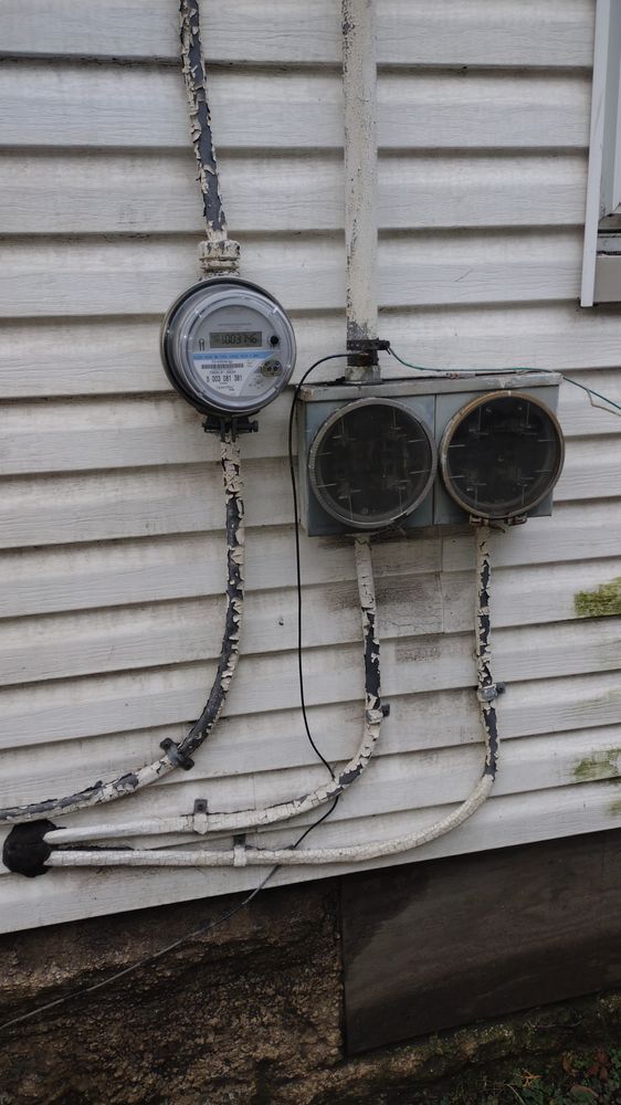 There is a meter on the side of a house.