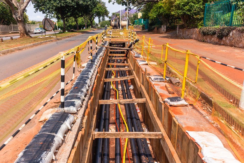 Trench Dug in a Road for Laying Cables — Gold City Solar & Electrical in Tin Can Bay, QLD