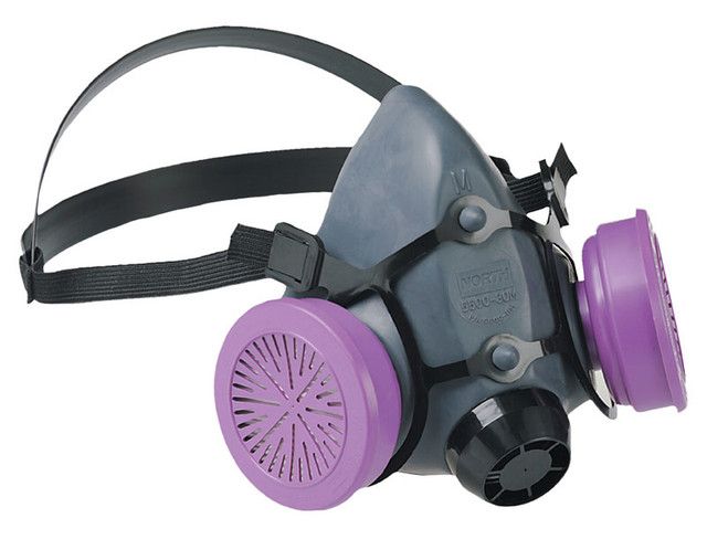 Half-face respirator with purple filters and black straps.