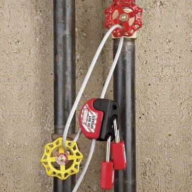 Pipes with locked valve handles, safety lock with red padlocks.