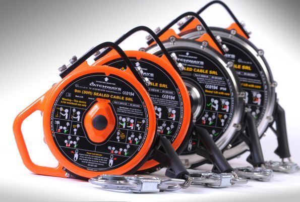 Three retractable fall arrest systems, orange and silver, on a white background.