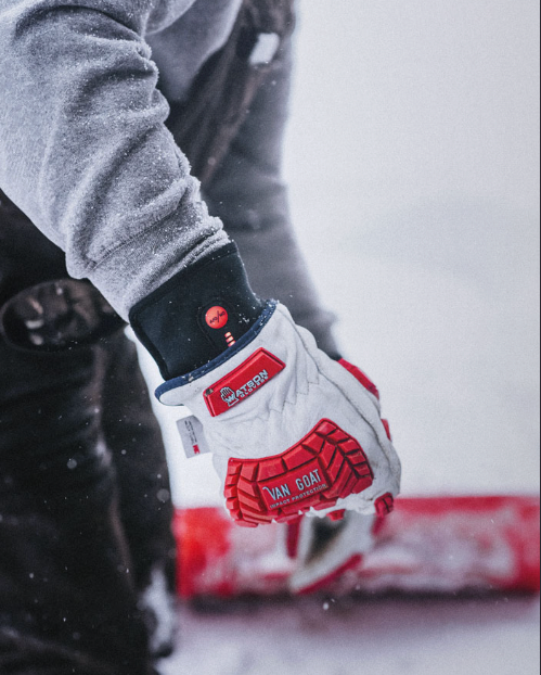 Person putting on yellow and black work gloves.