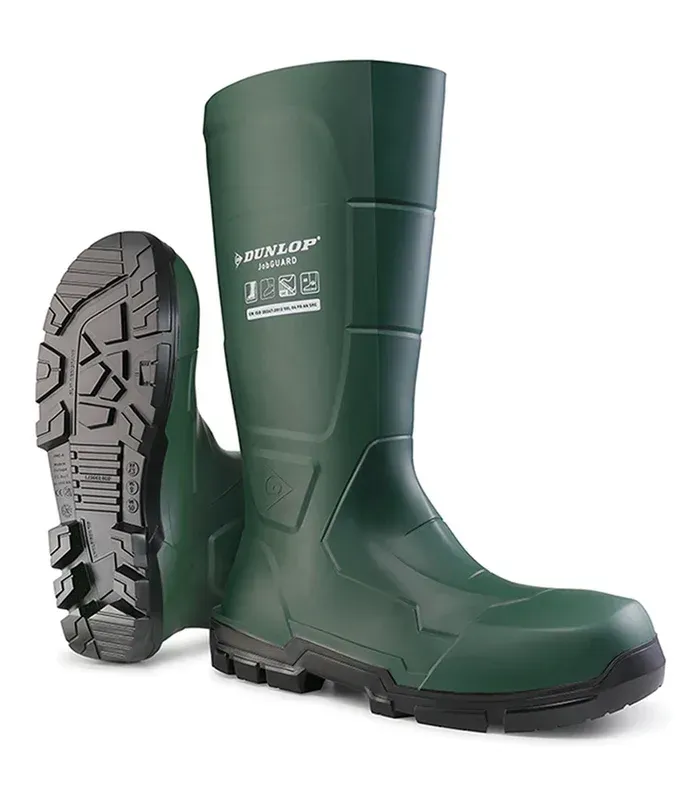 Green Dunlop Purofort safety boots. One boot is upright, the other showing its tread.