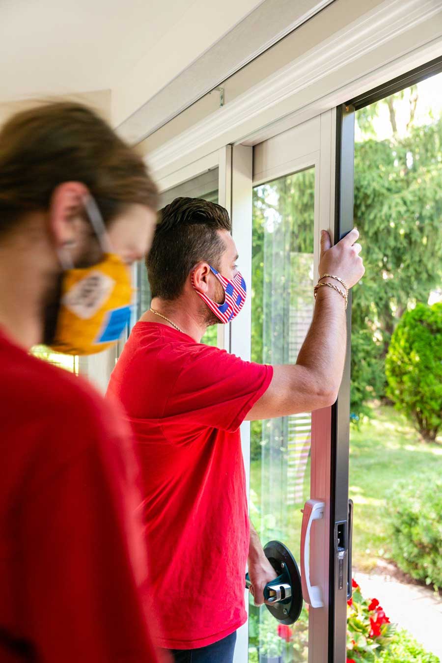 A Man Assisting His Boos  In Repairing The Sliding Door — Palatine, IL —  Sliding Door & Window