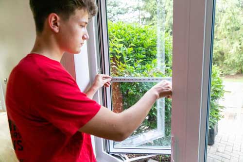 Young Man Fixing Glass — Palatine, IL —  Sliding Door & Window