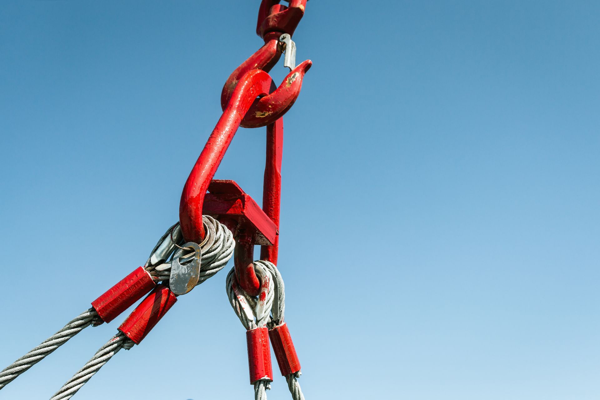 View of a crane hook with a blue sky in the background