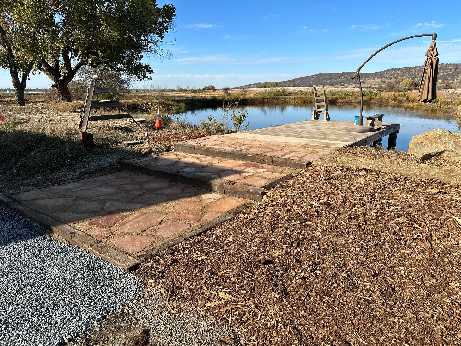 There is a dock in the middle of a lake.