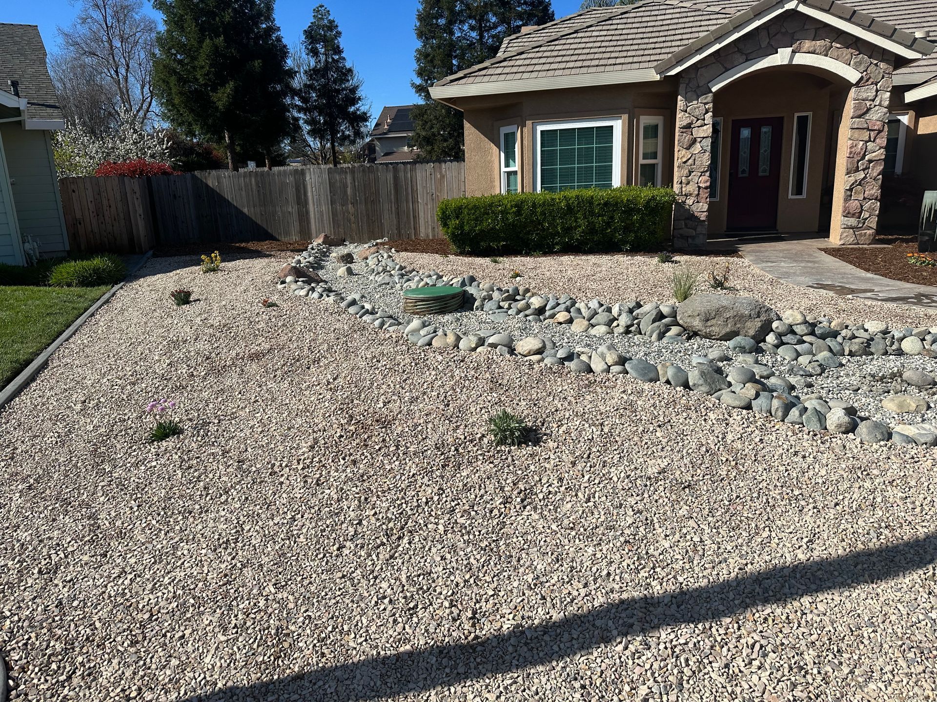 A house with a gravel driveway in front of it.