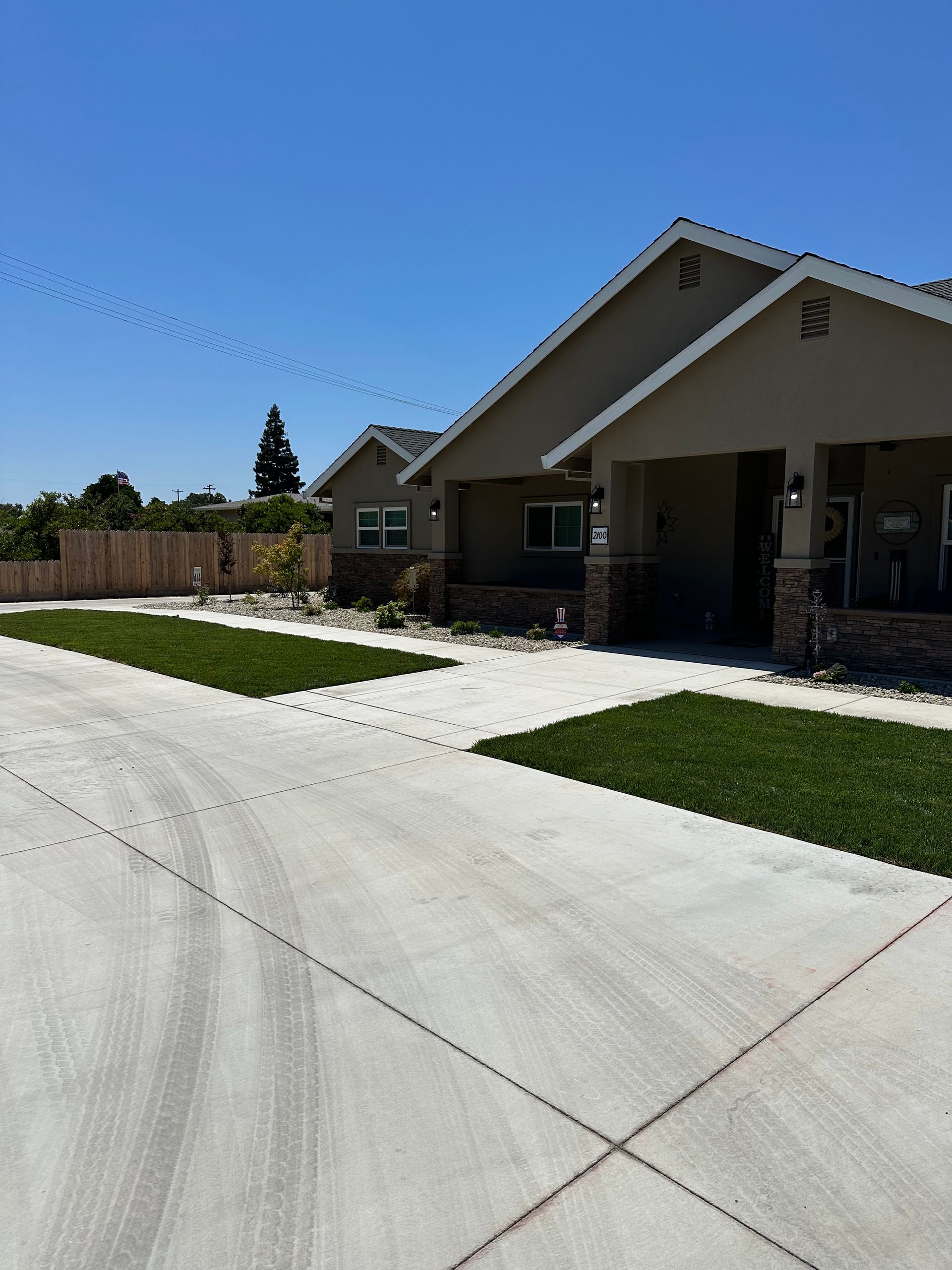 A house with a concrete driveway leading to it