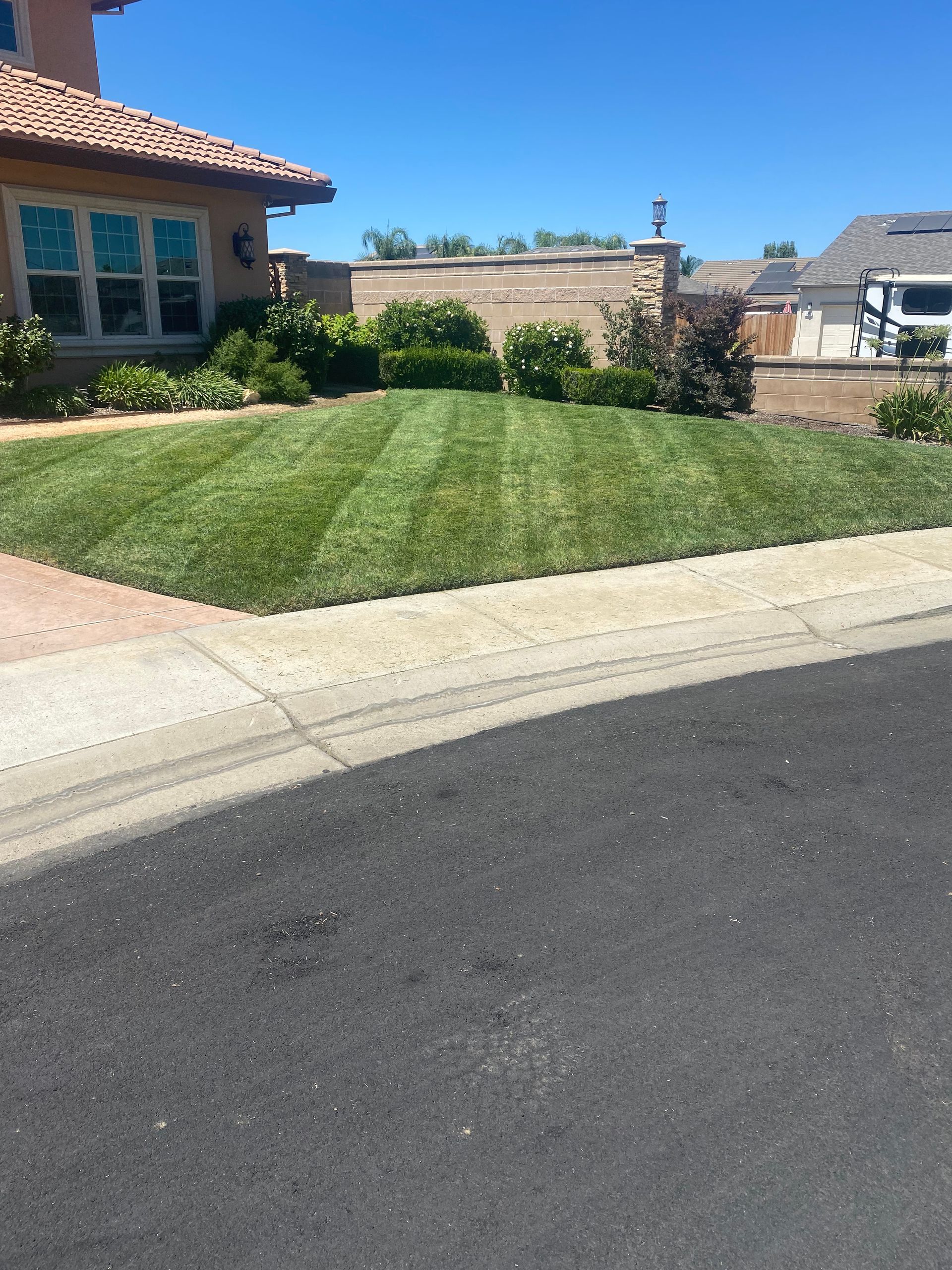 A house with a lush green lawn in front of it