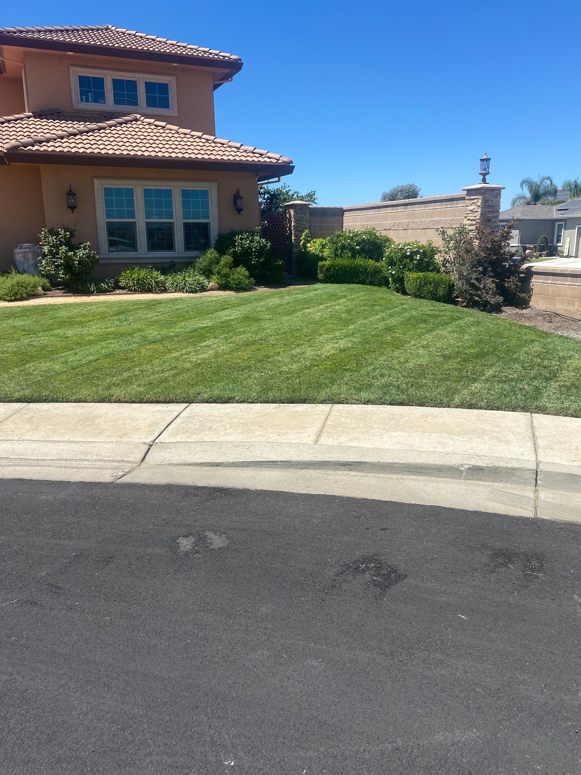 A large house with a lush green lawn in front of it