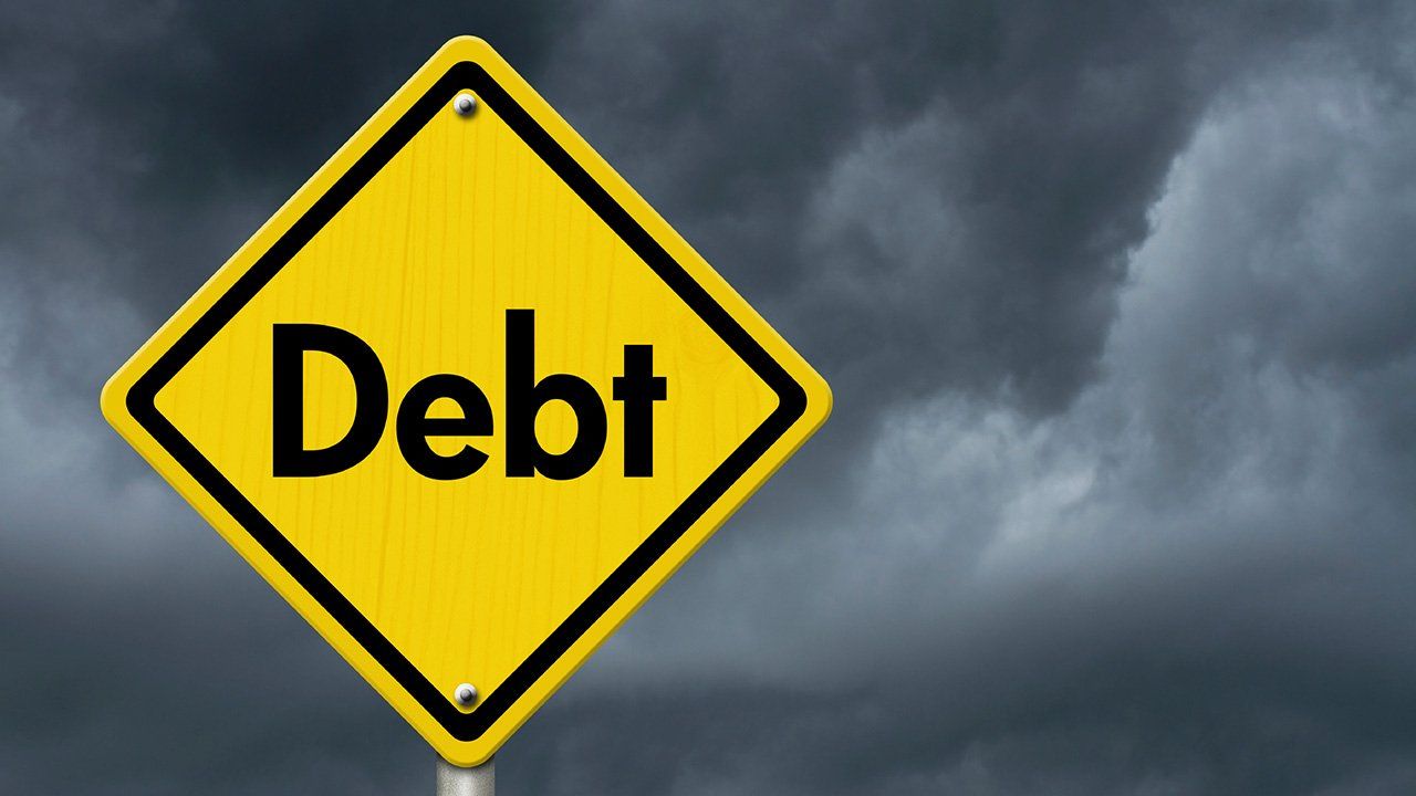 road sign that says debt
