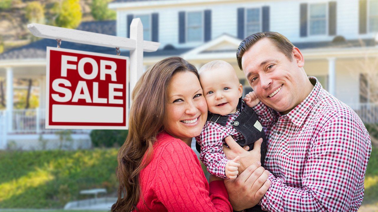 family in front of house for sale