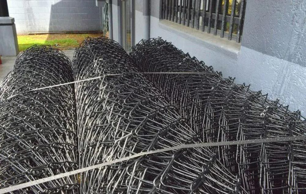 chain wire fencing rolls stacked outside in Cairns