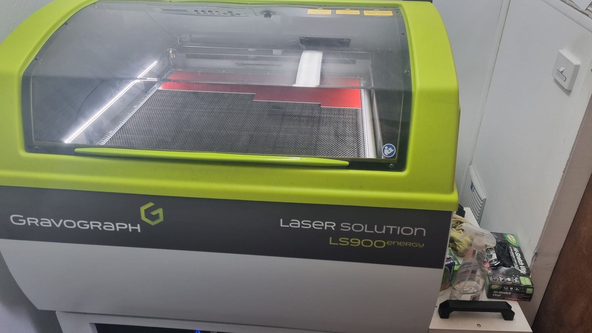 A machine is cutting a piece of metal with the number 28 on it.