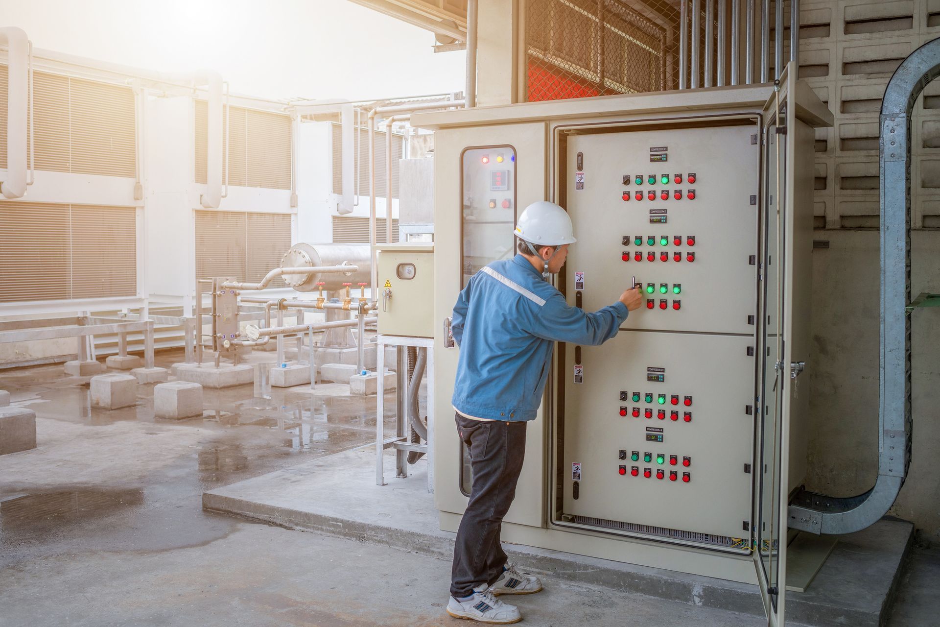 A young industrial engineer controlling a switchboard.