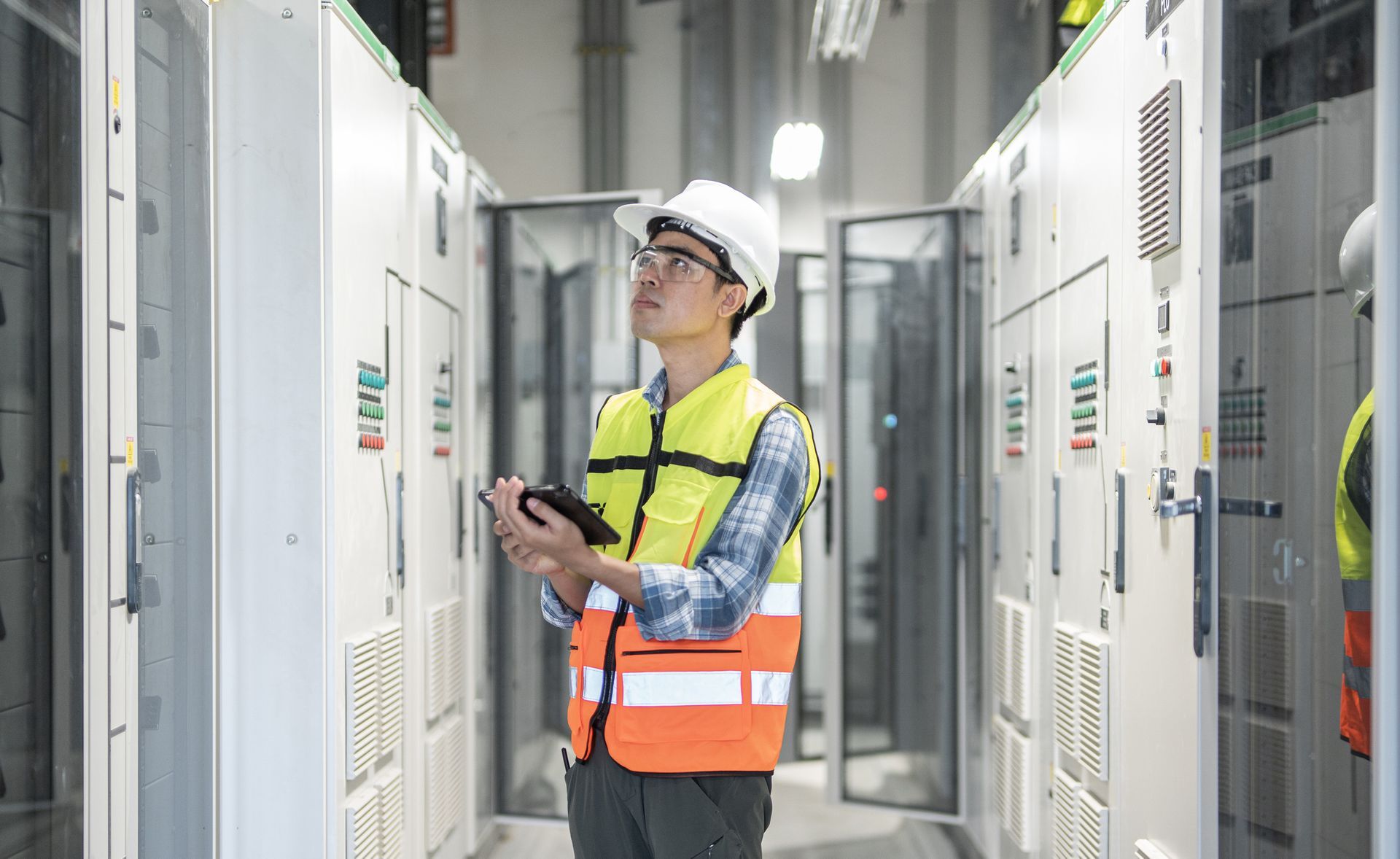 Electrician Engineer and Tablet Working at Electrical Room