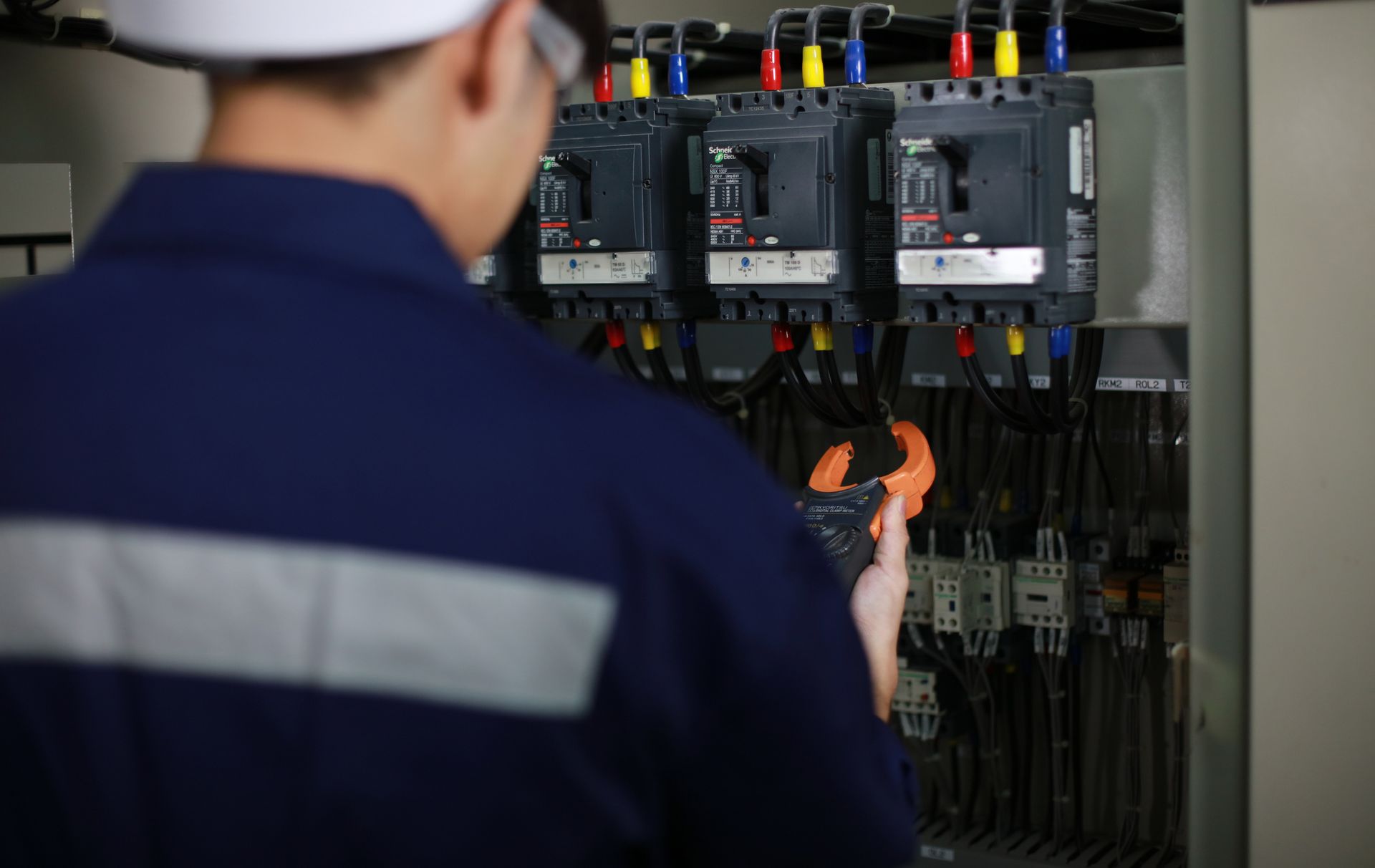 An electrical engineer checks and inspects a switchboard. An electrical engineer checks and inspects a switchboard.