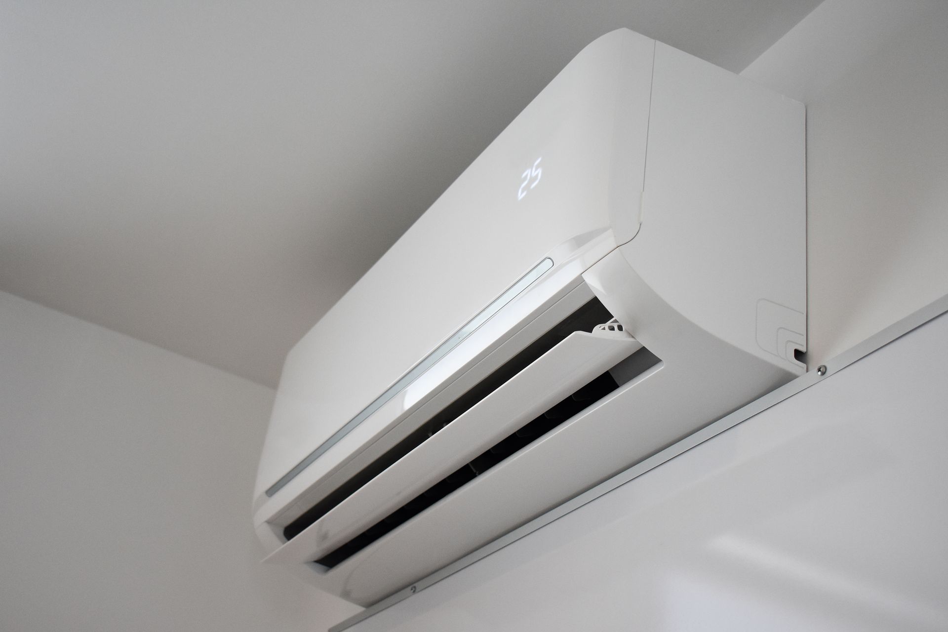 Mini-split air conditioning unit installed in a room.
