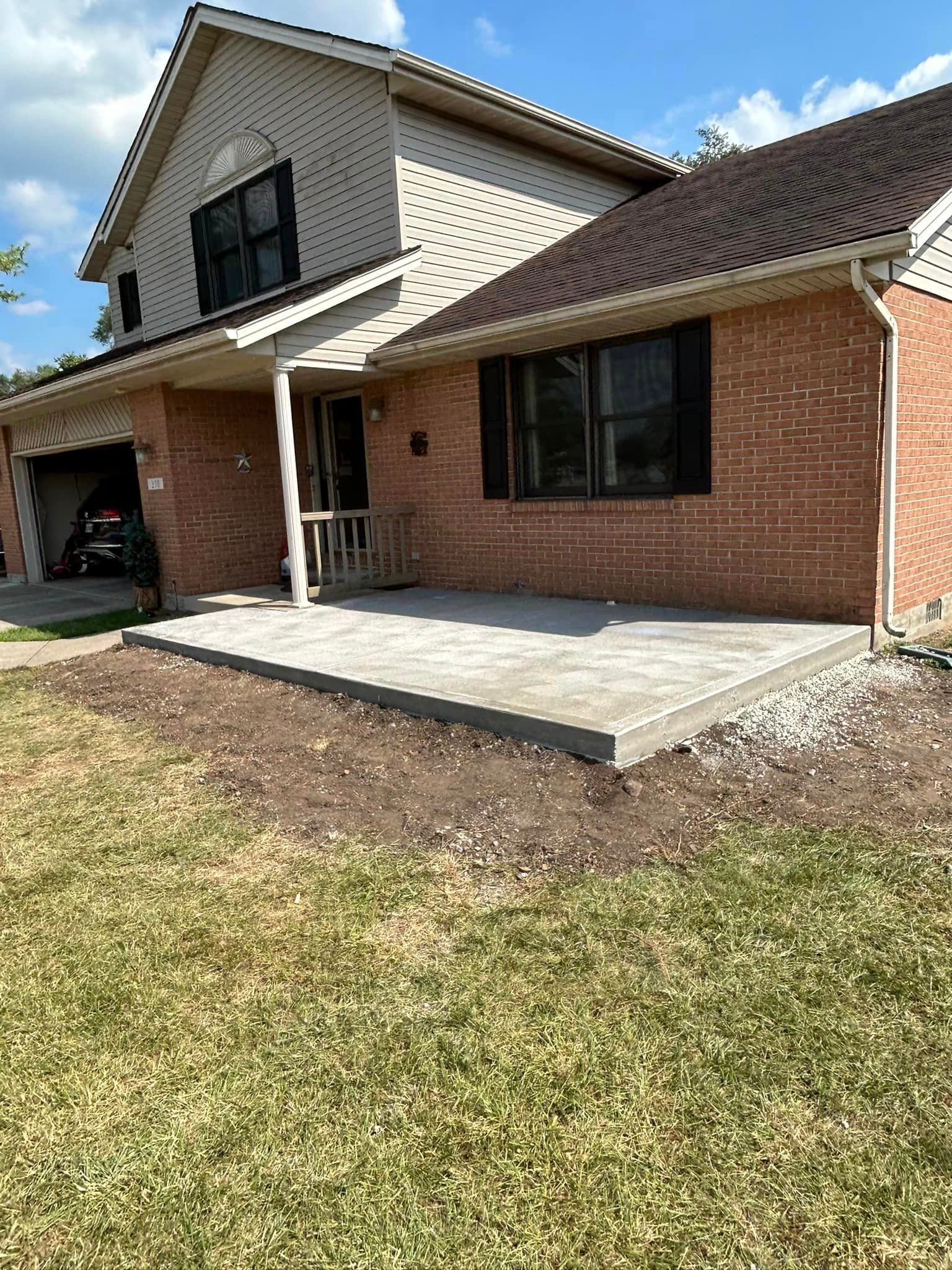 A Brick House With A Concrete Patio In Front Of It — Chesterton, IN — Claycor Construction