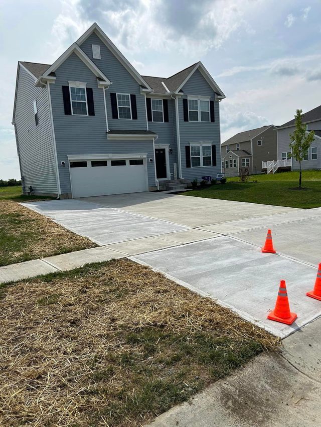 A Large House With A Concrete Driveway In Front Of It — Chesterton, IN — Claycor Construction