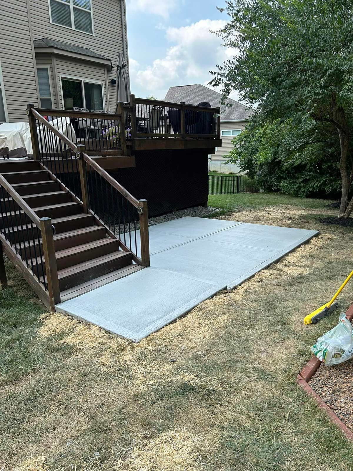 A Backyard With A Deck And A Concrete Walkway — Chesterton, IN — Claycor Construction
