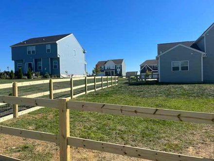 A Wooden Fence Surrounds A Green Field — Chesterton, IN — Claycor Construction
