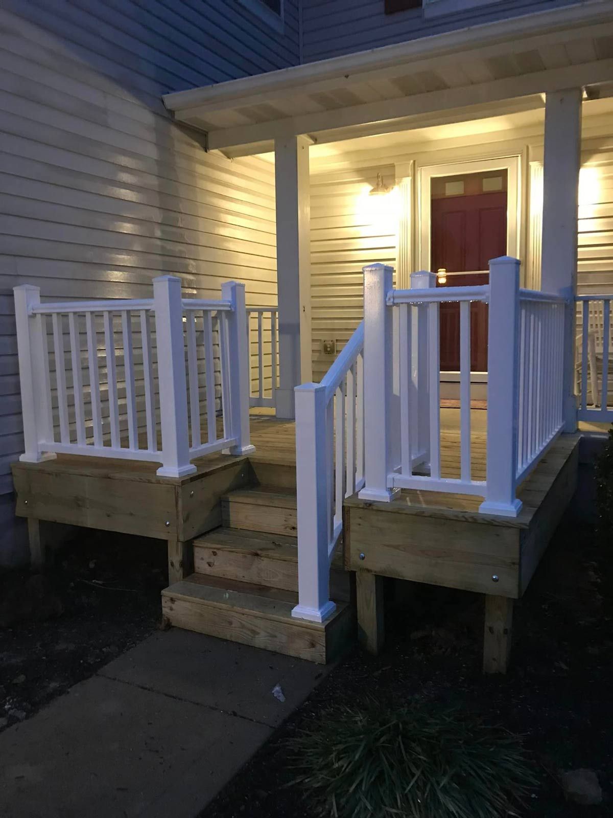 A Porch With A White Railing And Wooden Steps — Chesterton, IN — Claycor Construction