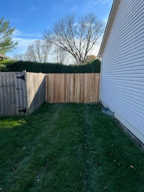 Wooden Fence In The Backyard Of A House — Chesterton, IN — Claycor Construction
