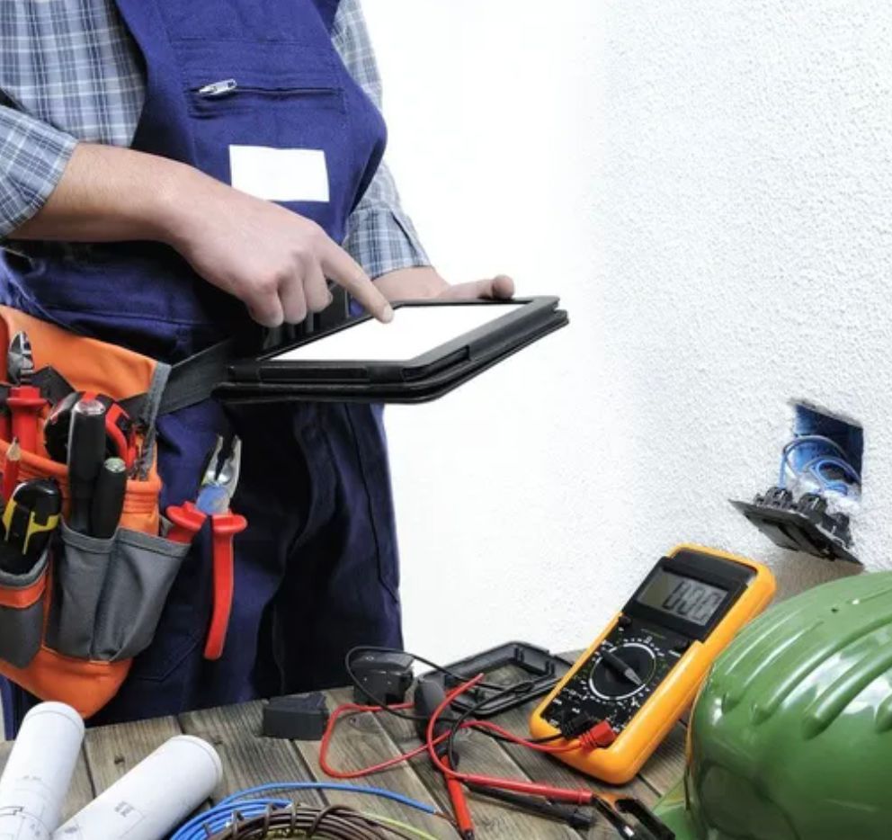A Man With a Tool Belt is Using a Tablet — Clifford Electrical in Ballina, NSW