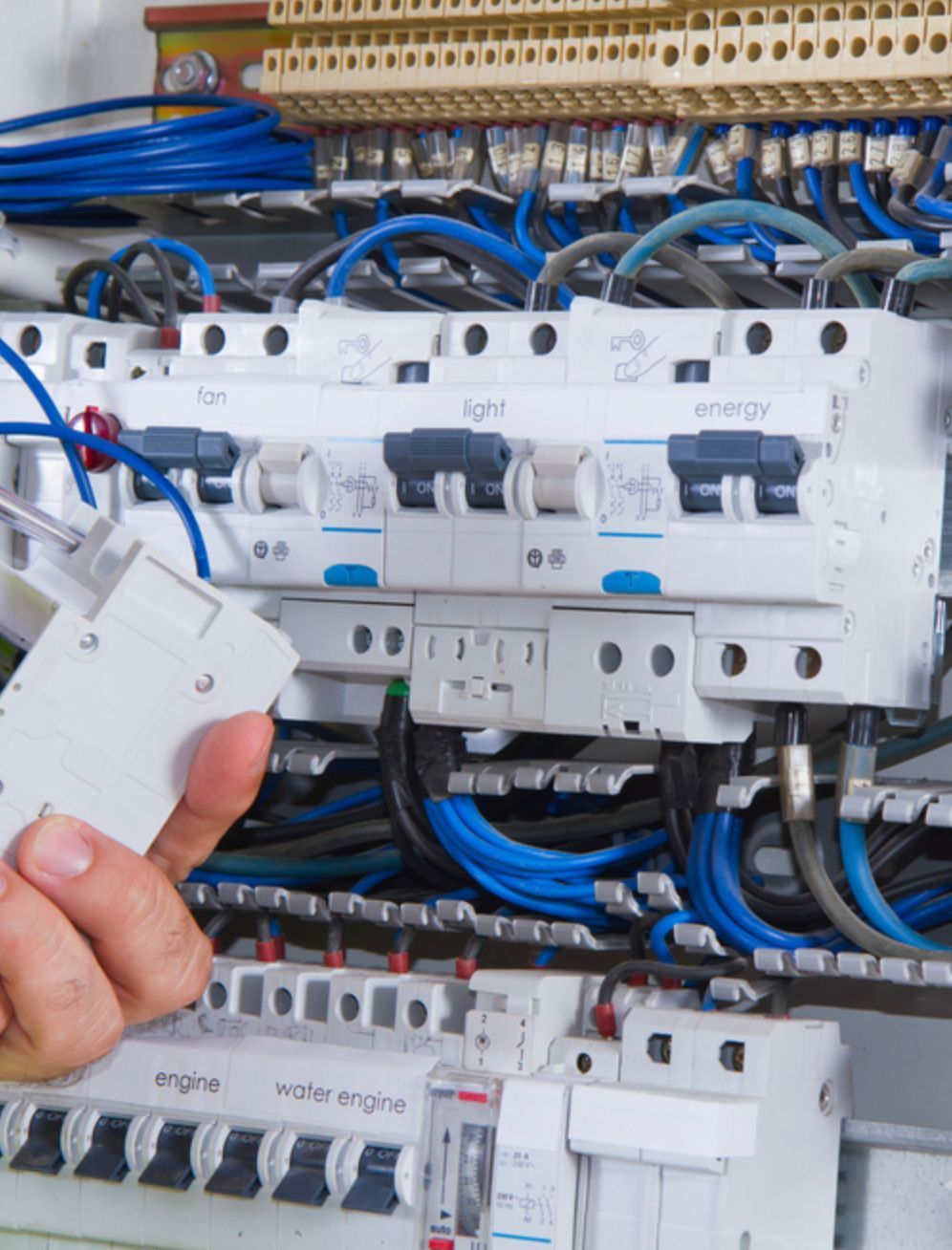 A Person is Working on an Electrical Box With a Screwdriver — Clifford Electrical in Alstonville, NSW