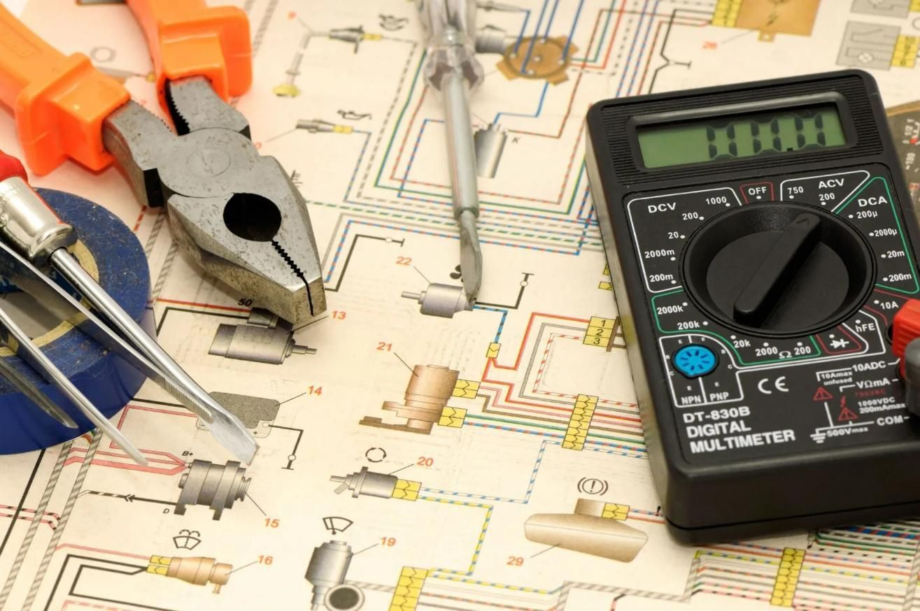 A Digital Multimeter is Sitting on Top of a Circuit Diagram — Clifford Electrical in Ballina, NSW