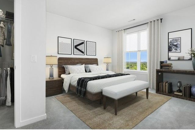 Bedroom at The Q with oversized windows.