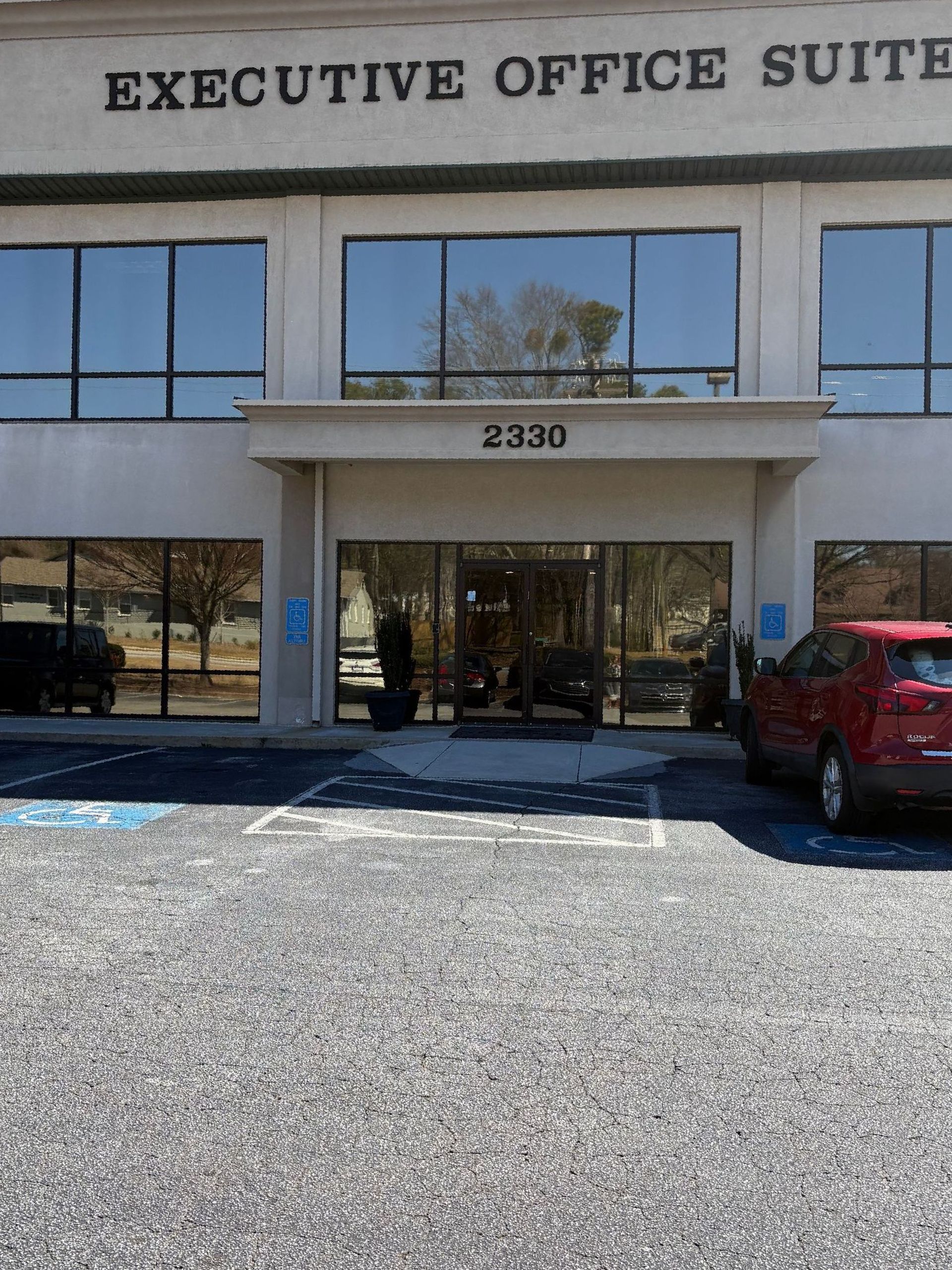 An executive office suite with cars parked in front of it