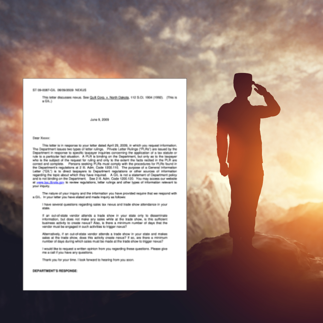 A man salutes while standing on top of a mountain next to a letter