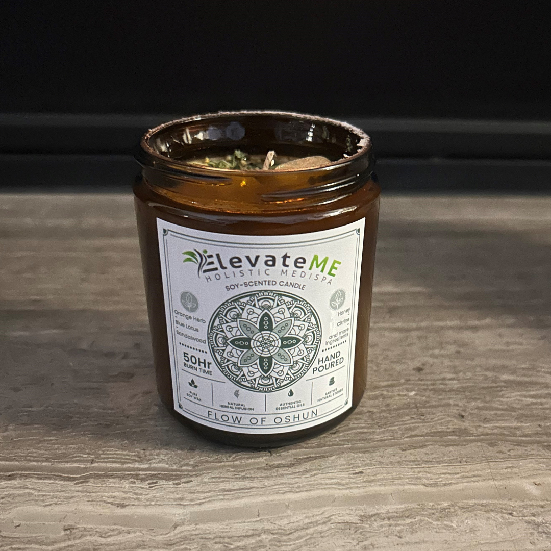 A brown jar filled with a candle on a white background.