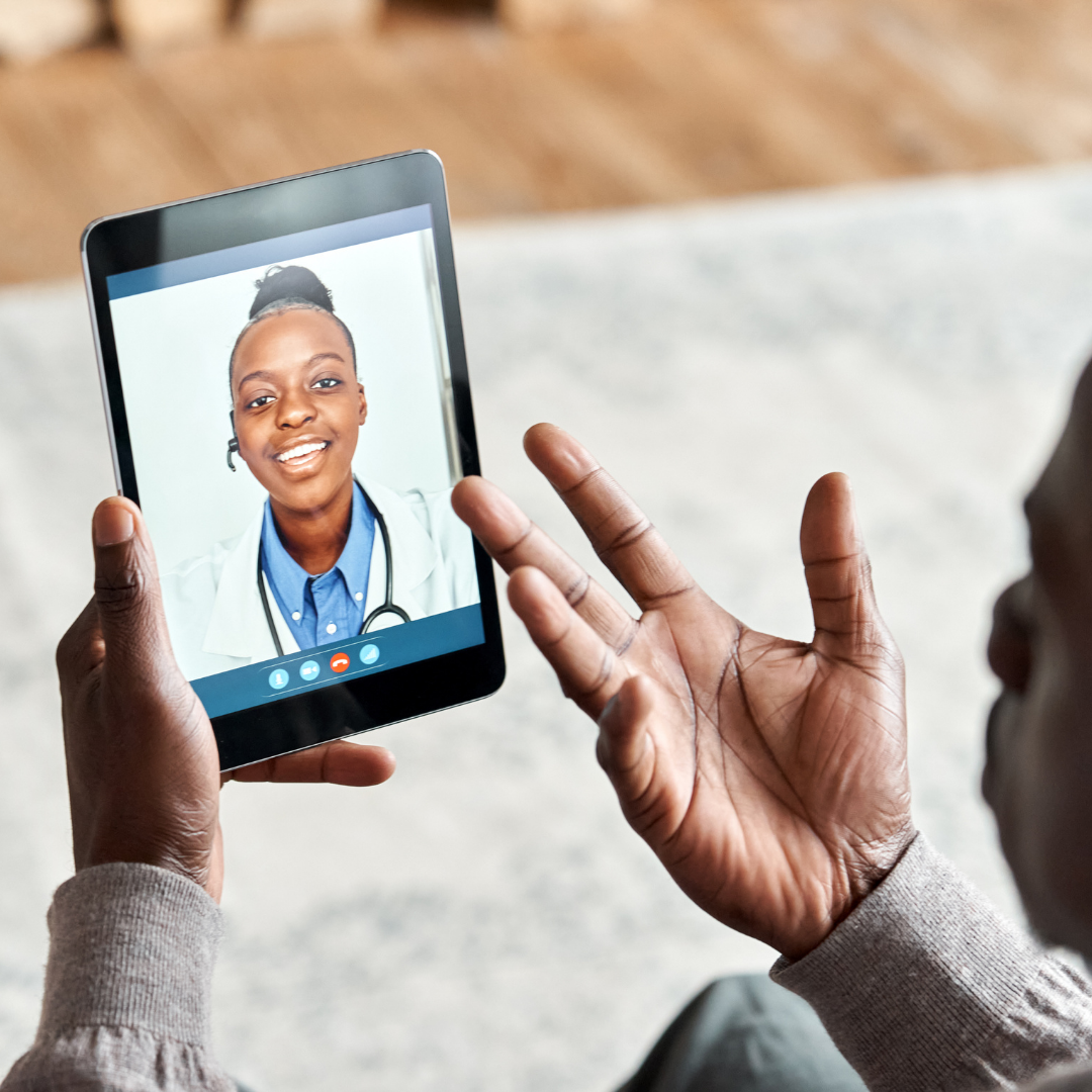 A person is holding a tablet with a picture of a doctor on it.