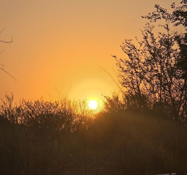 Sunset over El-Tsuri Guest Resort in Hartbeespoort, South Africa, with mountain views and tranquil evening light.