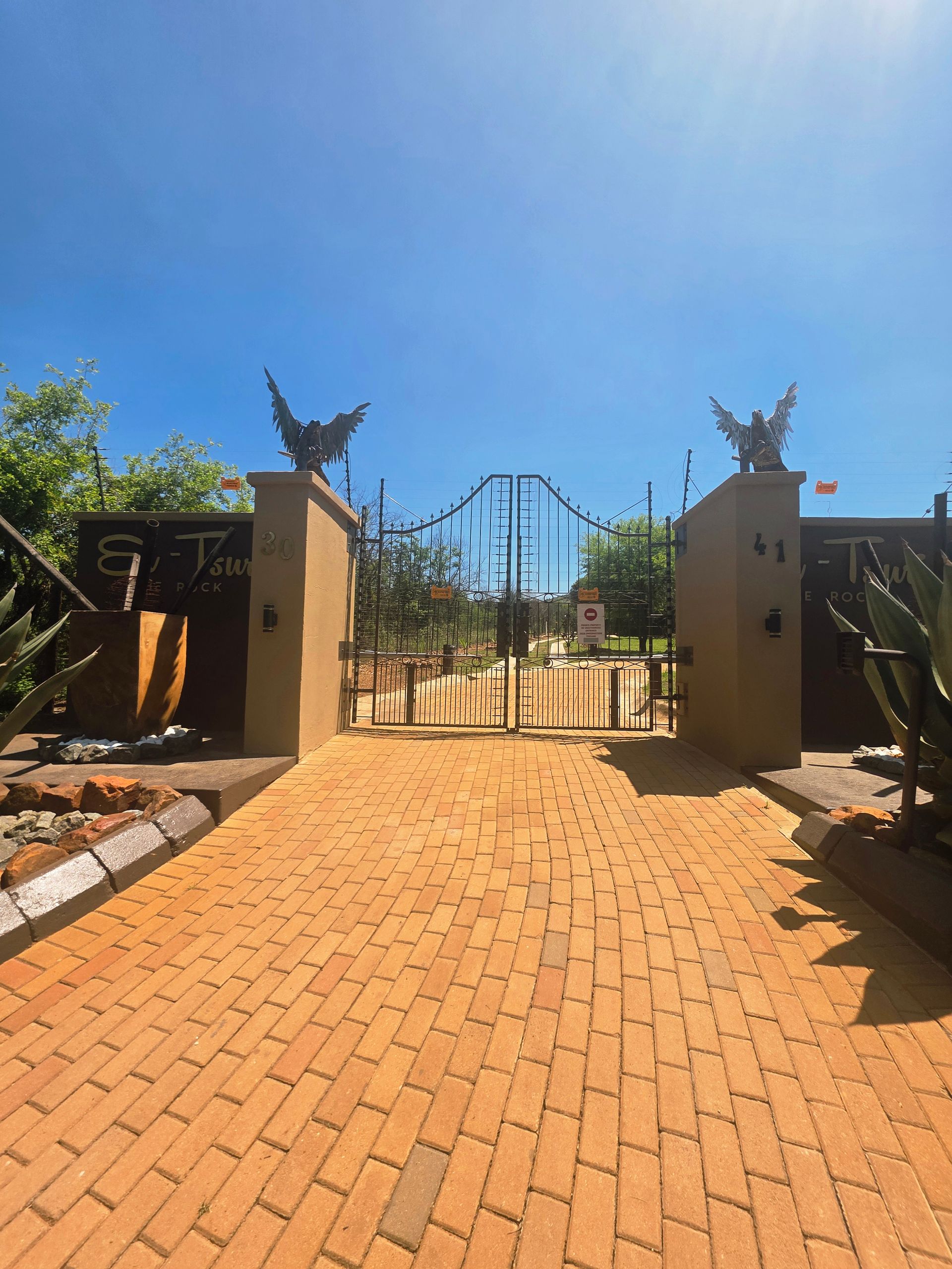 El-Tsuri guesthouse entrance gates in Hartbeespoort, South Africa. An elegant rustic gateway to a peaceful mountain retreat.