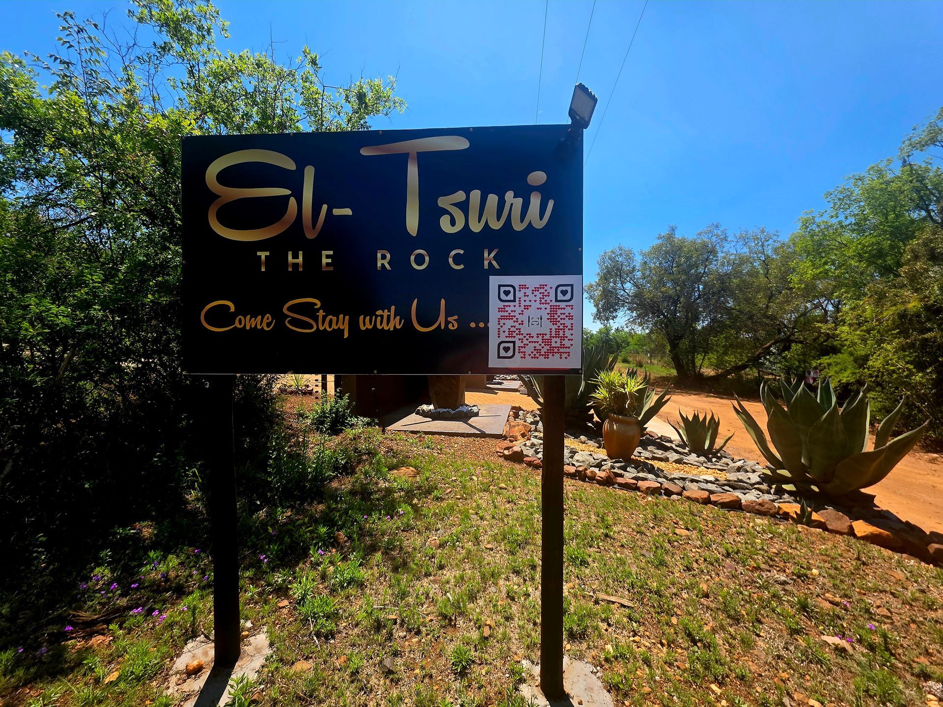 “El-Tsuri Guest Resort Hartbeespoort” Close-up of El-Tsuri entrance sign and gate, welcoming guests to a tranquil self-catering resort in Hartbeespoort.