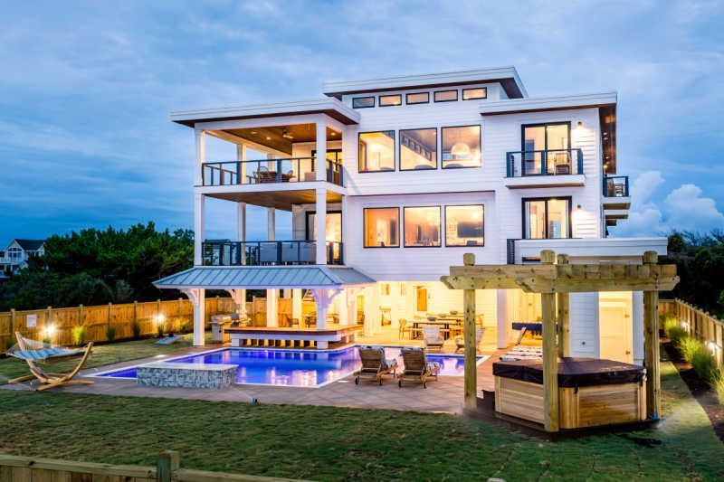 A vase of flowers is sitting on a table next to a window.