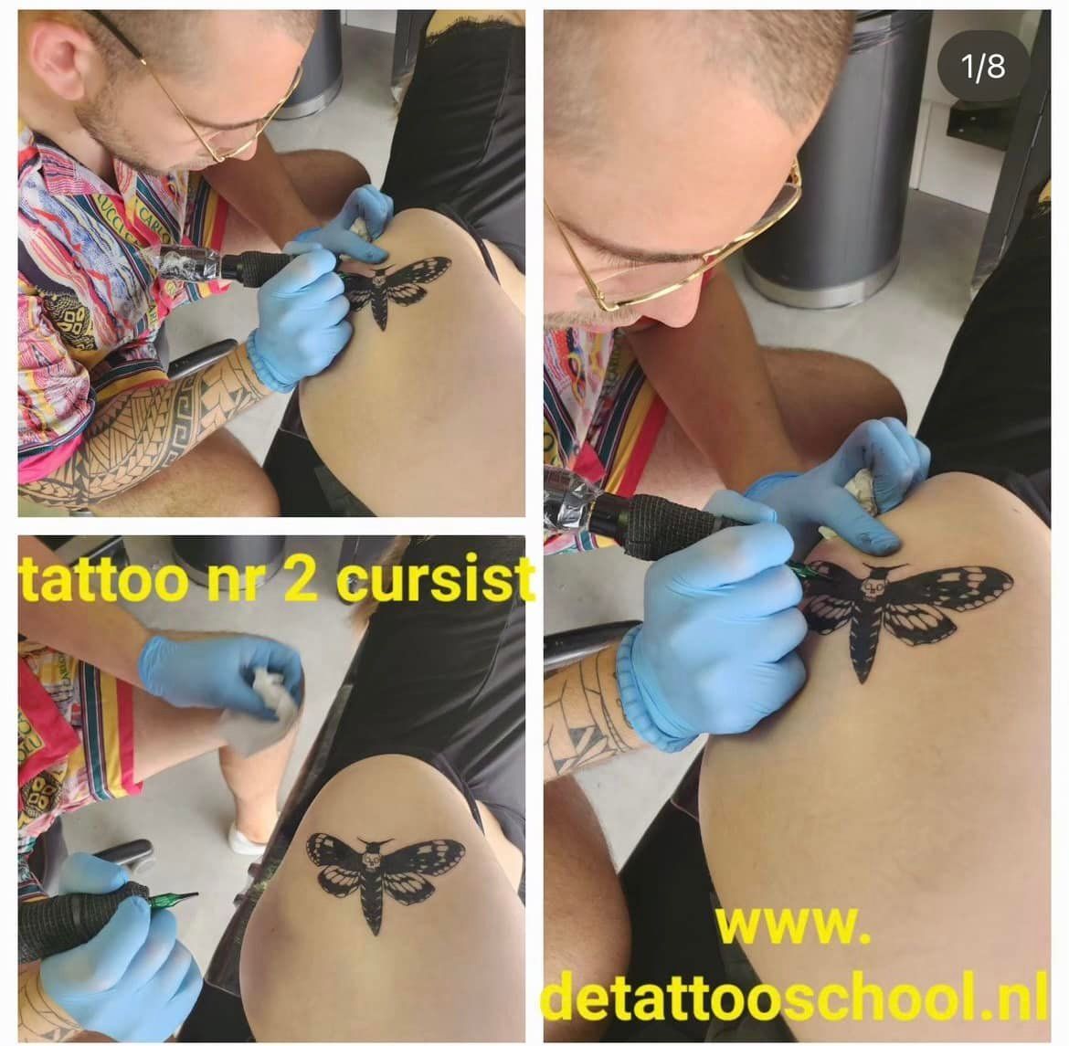 Tatoeëerder die iemand een tatoeage geeft. Een zwarte mot wordt op het lichaam getatoeëerd.