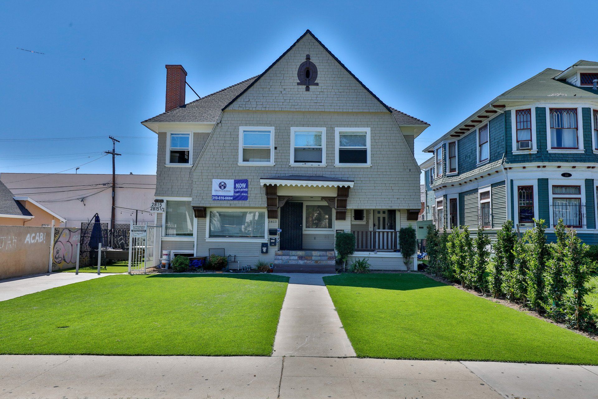 This image shows 2 houses and garden in front of her